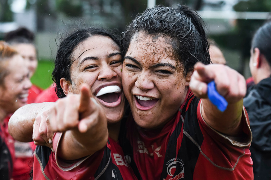 Two-female-rugby-athletes-cheer-and-point-to-camera.jpg